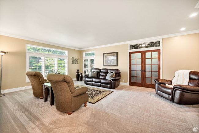 Carpeted living room featuring french doors and crown molding | Image 27