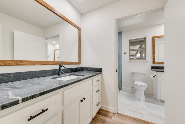 Bathroom featuring vanity and marble finish floors | Image 21