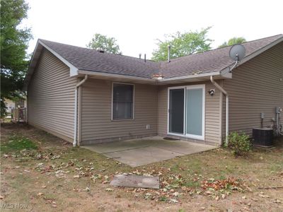 Patio in rear with sliding door that has adjustable louvers for privacy or openness | Image 3