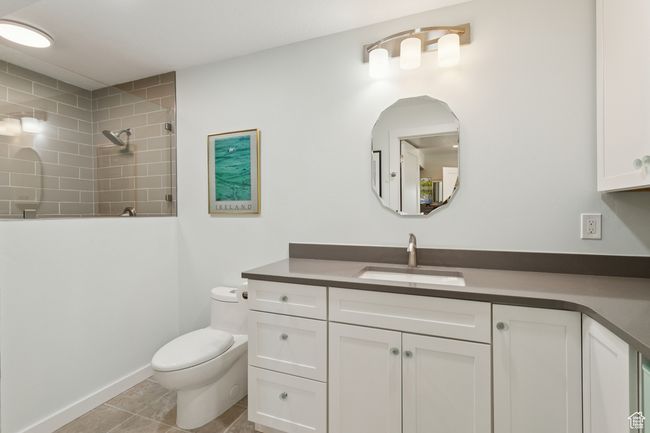Bathroom with vanity, tiled shower, and tile patterned floors | Image 34