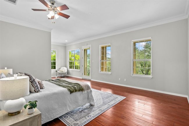The primary looks onto the backyard and pool and is bright and airy. | Image 16
