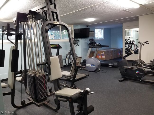 Exercise room featuring a textured ceiling | Image 31