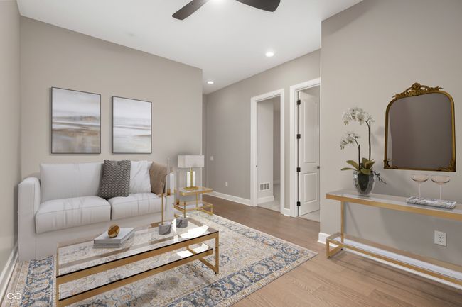 Spacious primary bedroom with ceiling tray and wood beams, large windows offering natural light. | Image 16
