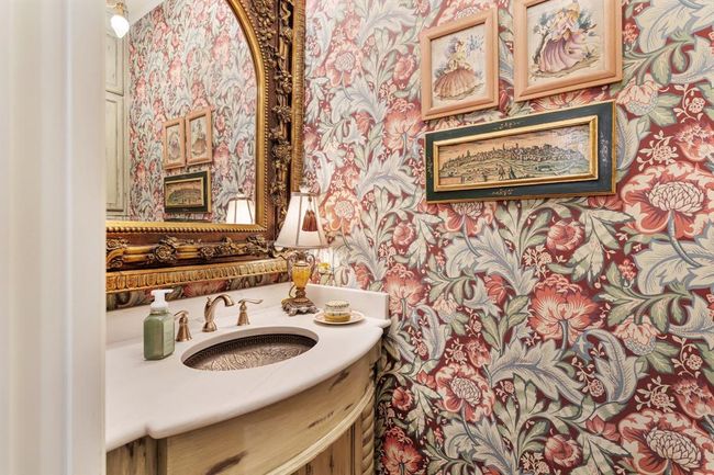 The Primary Powder Bath located in the hallway off thekitchen, is resplendent in "Acanthus Garden" by Seabrook Designs, Legacy Prints, made in the Netherlands. This half bath is absolutely gorgeous! | Image 20