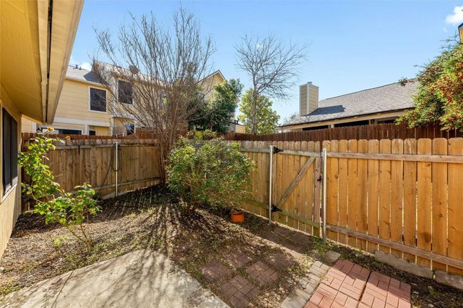 View of yard with a gate and fence | Image 16