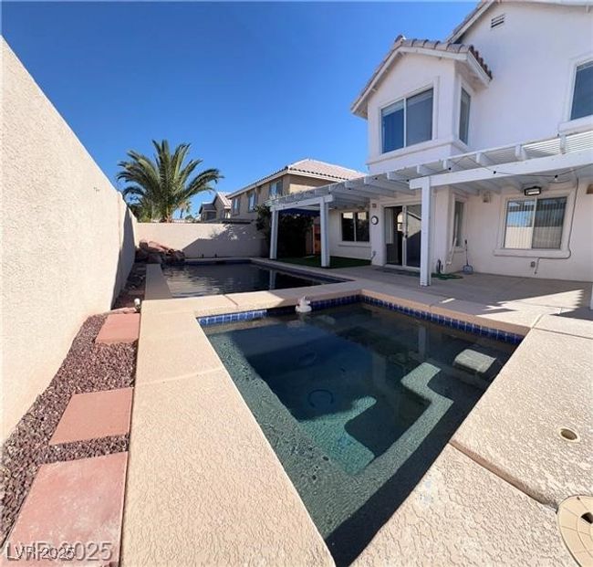 View of swimming pool featuring a fenced backyard, a fenced in pool, a pergola, and a patio | Image 14