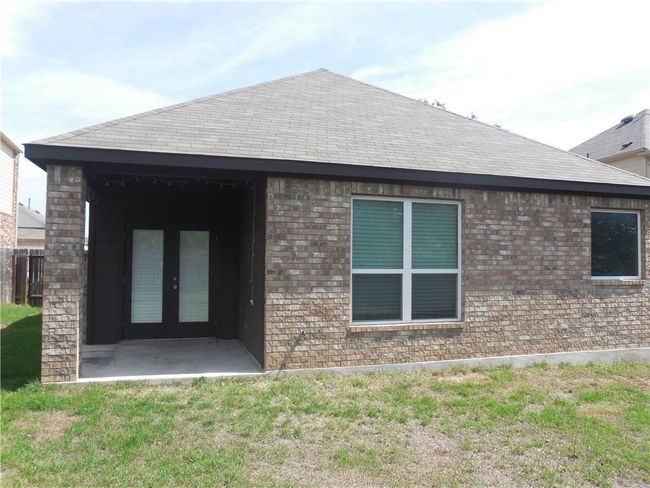 Back of property with french doors, brick siding, a yard, and a shingled roof | Image 19