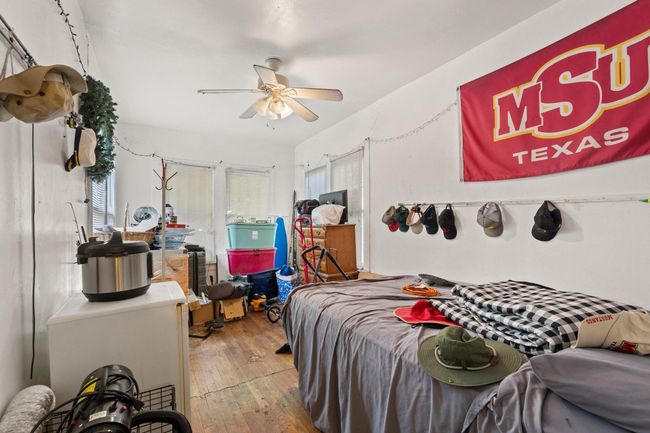 Bedroom with hardwood / wood-style flooring and ceiling fan | Image 11