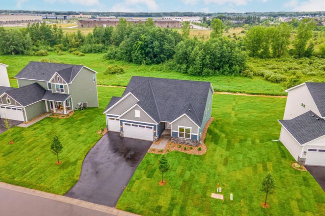 Attractive from every angle, this home features low-maintenance landscaping, a spacious driveway, and modern siding with complementary stonework. | Image 42