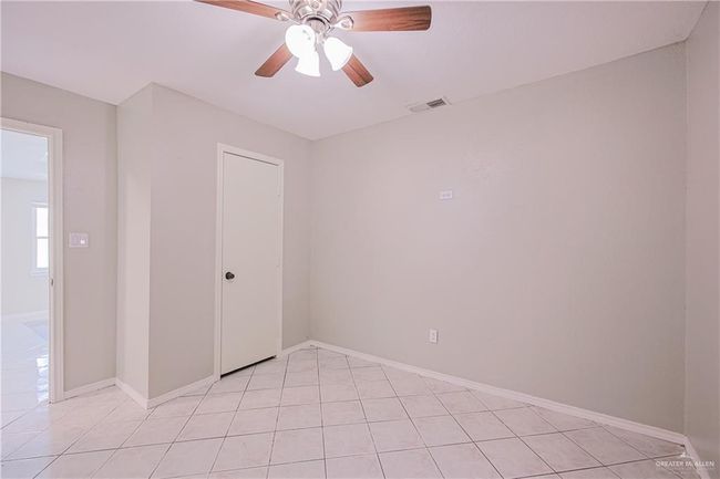 Unfurnished room with light tile patterned floors, visible vents, ceiling fan, and baseboards | Image 19