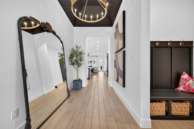 Extended hallway with high ceilings and a spacious layout that leads into the main living area. The streamlined design and open flow offer a seamless transition through the home. | Image 6