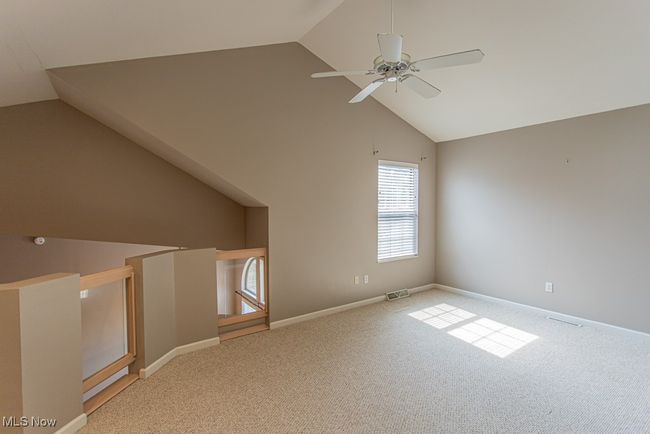 Bonus room featuring carpet, ceiling fan, and high vaulted ceiling | Image 23