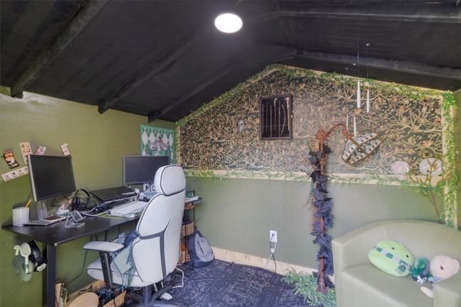 Storage shed converted to home office with vaulted ceiling and A/C unit. | Image 27