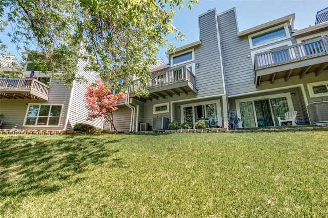 Back of property with central AC unit, a yard, and a chimney | Image 20