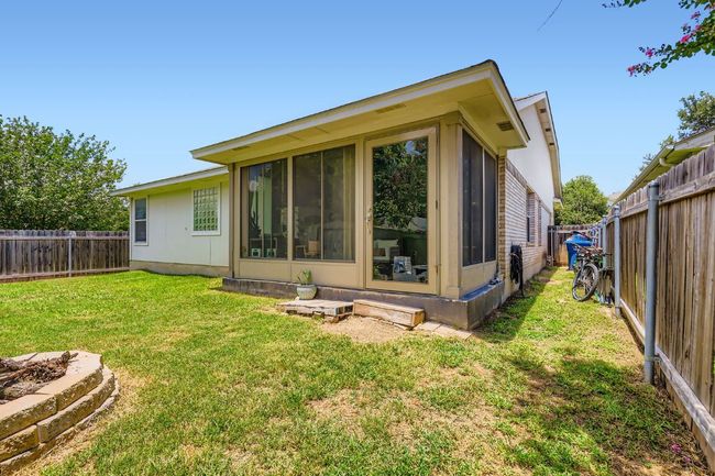 Back of property with a fenced backyard and a sunroom | Image 26