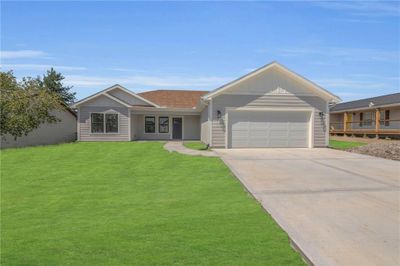 Single story home with a garage and a front yard | Image 2