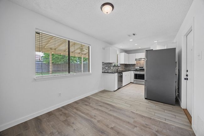 Kitchen featuring white cabinets, dark countertops, visible vents, a textured ceiling, and appliances with stainless steel​​‌​​​​‌​​‌‌​‌‌​​​‌‌​​‌‌​‌​​​​​‌ finishes | Image 14