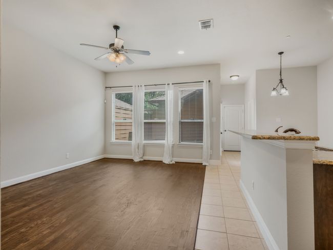 Unfurnished living room with a ceiling fan, light wood finished floors, and recessed lighting | Image 15
