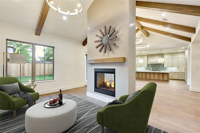 This intimate den-like nook, complete with a double-sided fireplace, offers a serene space for quiet reading, casual lounging, or cozy evenings in. Virtually staged. | Image 11