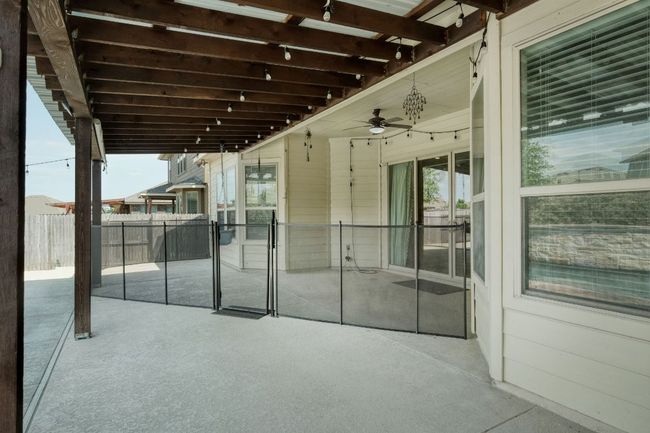 View of patio with child safety fence and ceiling fan | Image 30