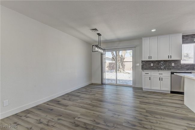 Kitchen featuring stainless steel dishwasher, tasteful backsplash, white cabinets, baseboards, and recessed lighting | Image 16