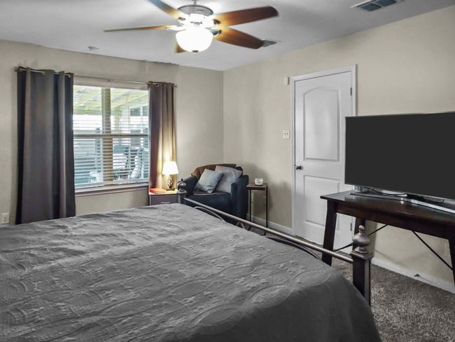 Carpeted bedroom featuring ceiling fan and baseboards | Image 16