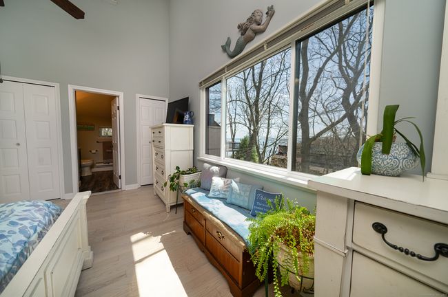Main bedroom has an extra large window with water views | Image 12