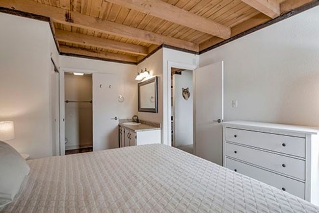 Bedroom featuring wooden ceiling, a sink, and beam ceiling | Image 13