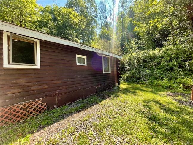View of property exterior with a yard | Image 8