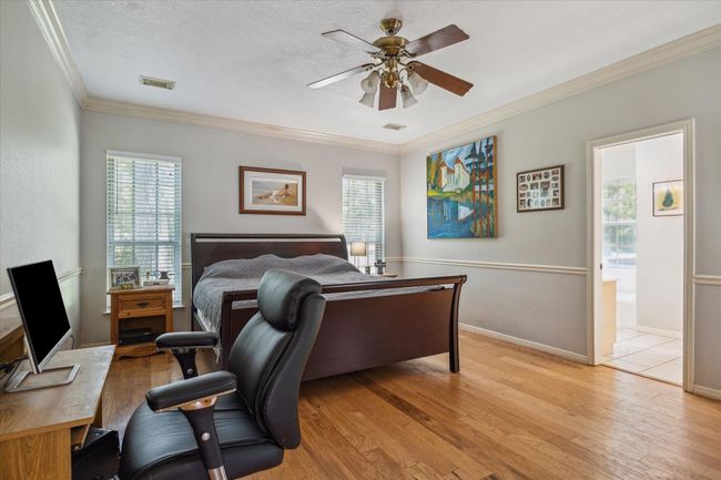 Charming two-story home with a welcoming front porch, nestled among mature trees. Features dormer windows, a classic gable roof, and a spacious yard, perfect for enjoying nature and outdoor activities. | Image 7