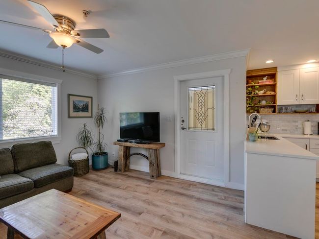 Living area with a ceiling fan, light wood-style flooring, baseboards, ornamental molding, and recessed lighting | Image 13