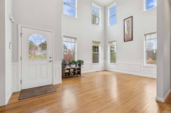 Dining room with baseboards and light wood-type flooring | Image 4