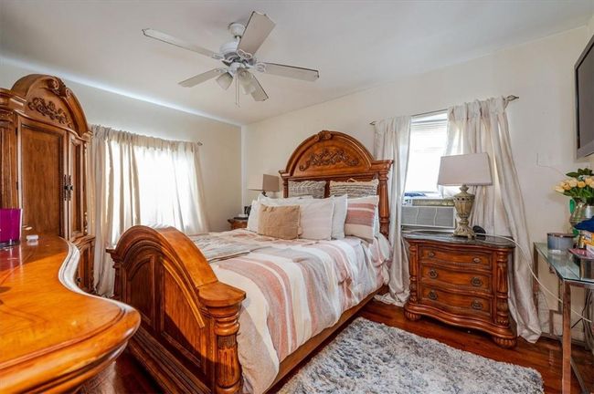 Bedroom with wood-type flooring and ceiling fan | Image 8