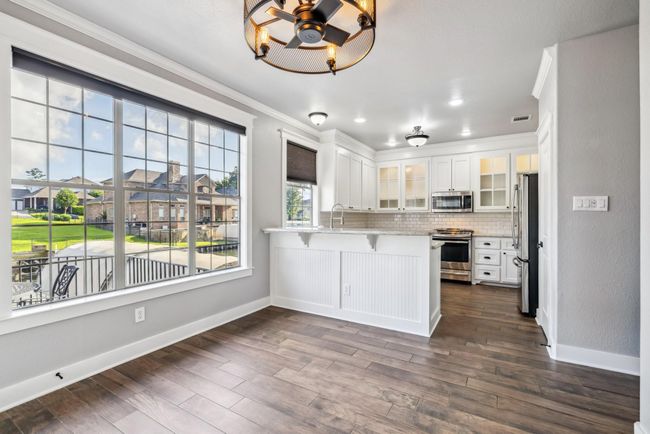 The breakfast room and kitchen have lots of natural light and overlook the water | Image 14