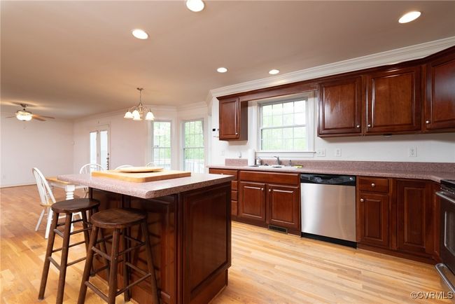 Eat-in kitchen featuring a nice island and breakfast bar | Image 17