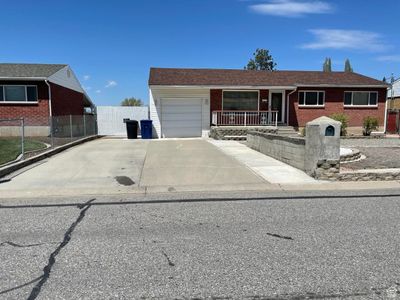 Ranch-style house featuring a garage | Image 2