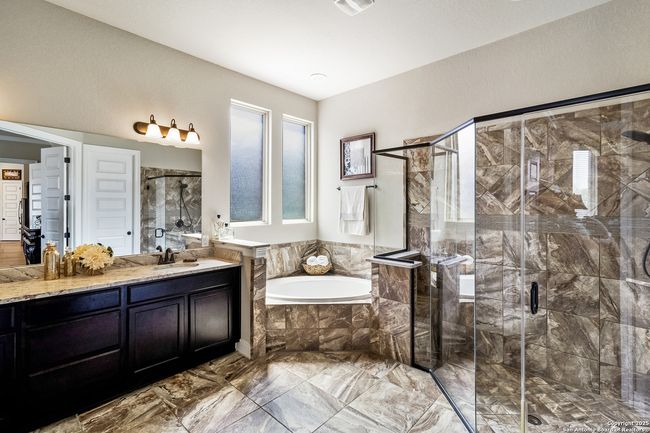 Elegant primary bathroom featuring a spa-like ambi | Image 24