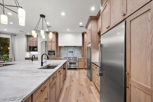 A second angle reveals seamless flow into the living space and the inviting ambiance that comes from thoughtful lighting and layout. | Image 16