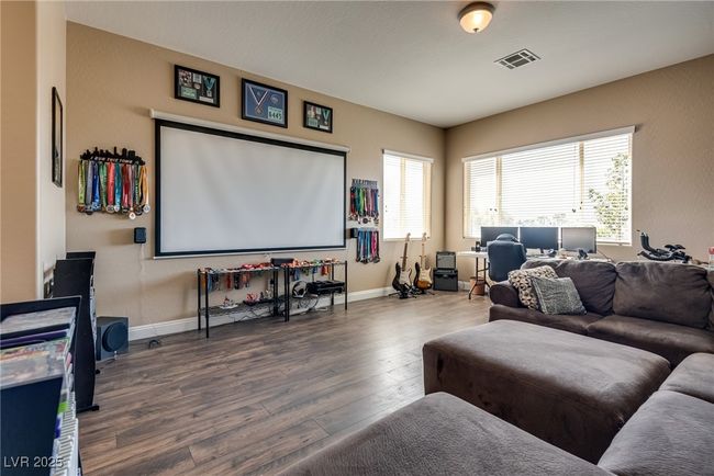 Home theater room featuring baseboards, visible vents, and wood finished floors | Image 37