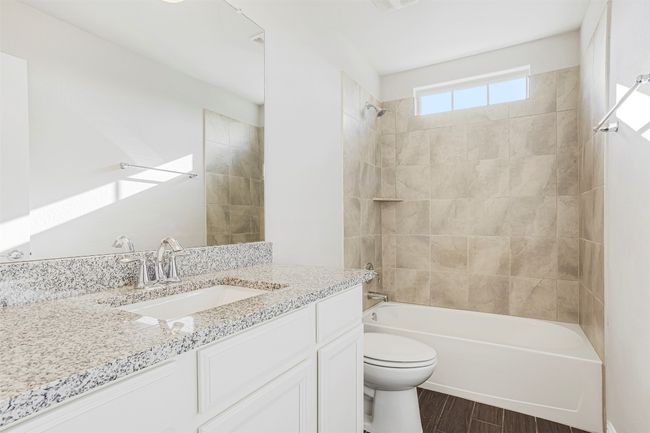 Full bathroom with vanity, shower / bath combination, and wood finished floors | Image 32