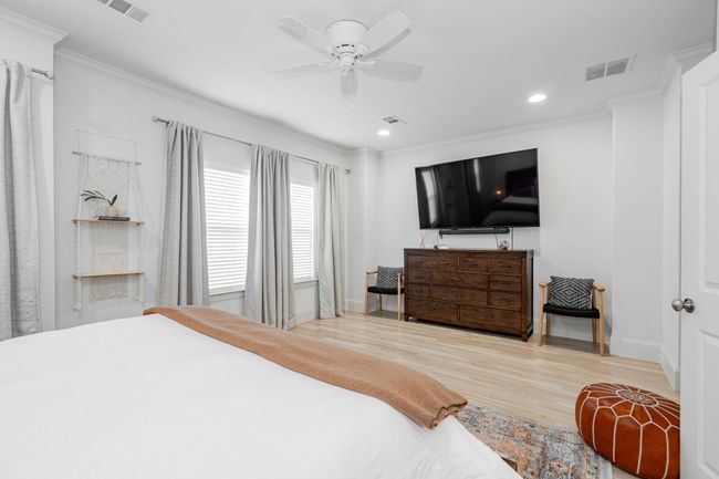 Bedroom with ornamental molding, and wood finished floors | Image 19