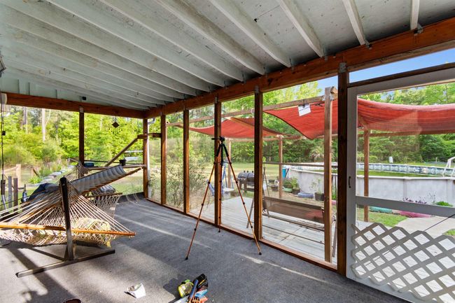 Unfurnished sunroom featuring a water view | Image 28