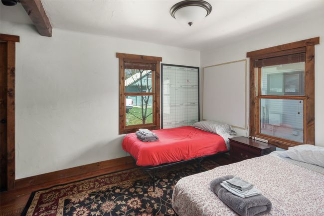 Bedroom with wood finished floors and beamed ceiling | Image 20