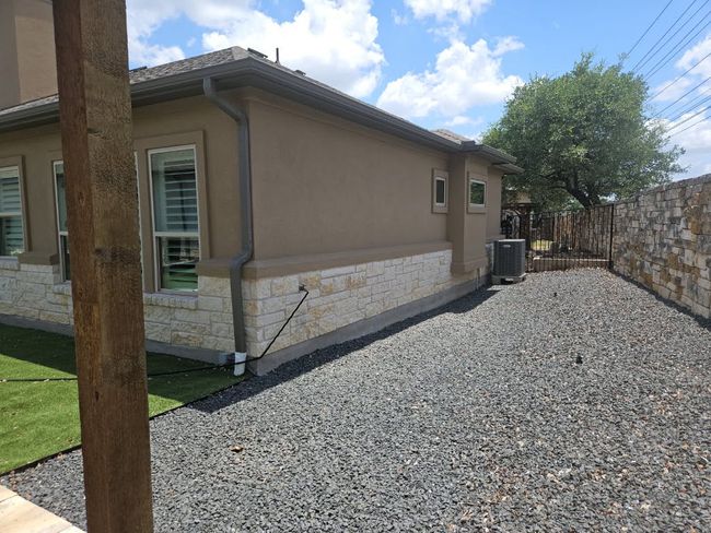 View of home's exterior with stone siding and stucco siding | Image 21