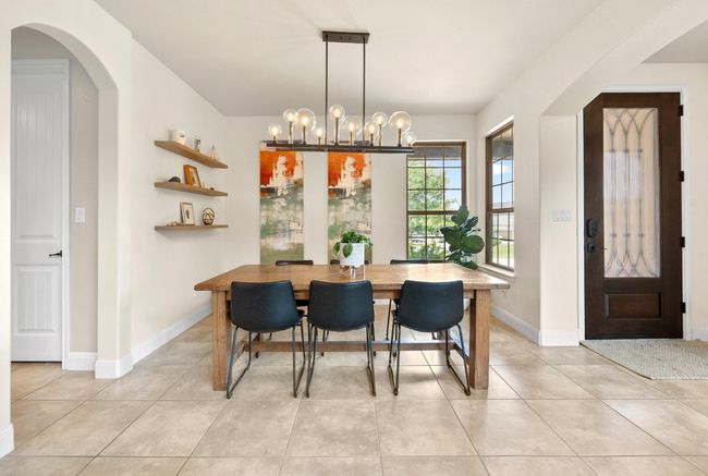 Dining area with beautiful chandelier open to living room | Image 6