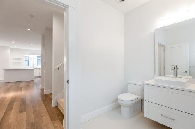 Bathroom featuring baseboards, wood finished floors, vanity, and toilet | Image 12