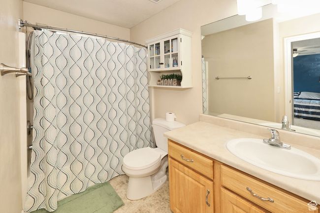 Full bath with curtained shower, vanity, connected bathroom, and toilet | Image 11
