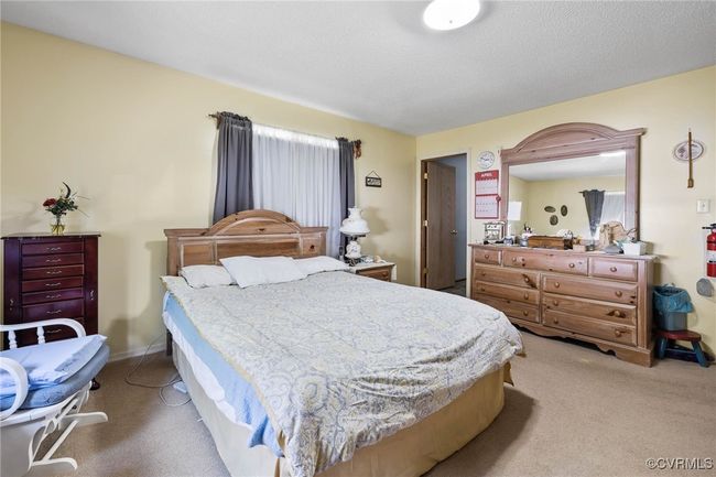 Bedroom featuring light carpet | Image 9