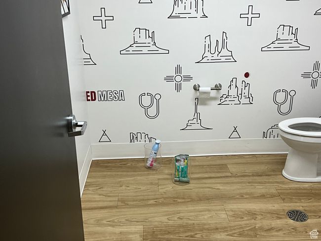 Bathroom featuring baseboards, toilet, and wood finished floors | Image 20