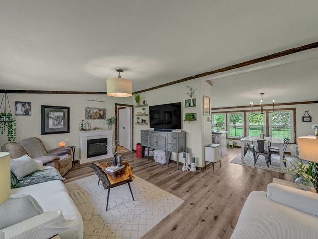 Living room featuring light wood-style floors, house two. | Image 23